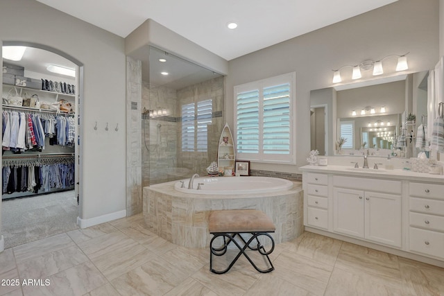 bathroom with vanity and independent shower and bath