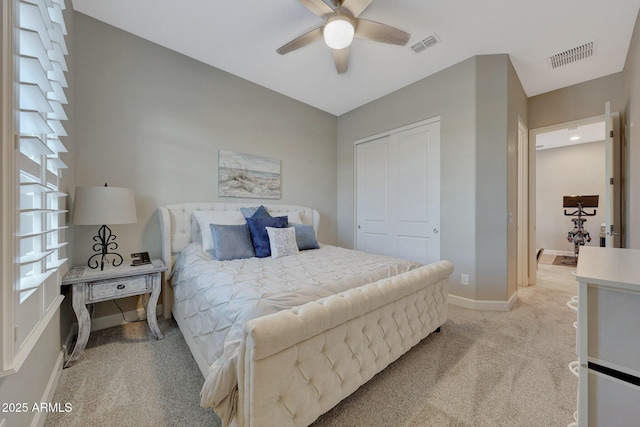 carpeted bedroom featuring ceiling fan and a closet