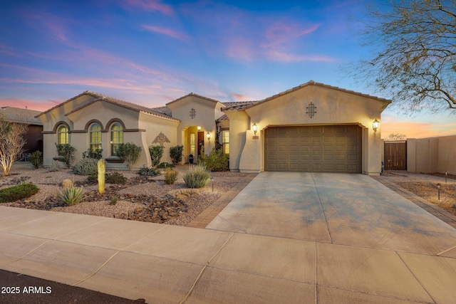 mediterranean / spanish home featuring a garage