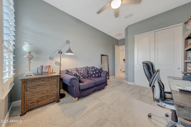 carpeted office space featuring lofted ceiling and ceiling fan