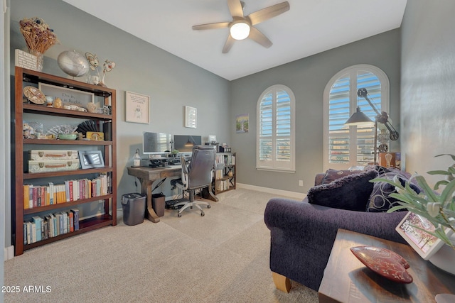 carpeted office featuring ceiling fan