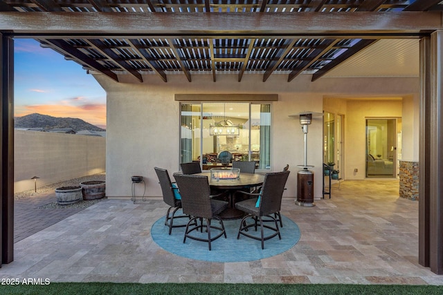 patio terrace at dusk featuring a pergola