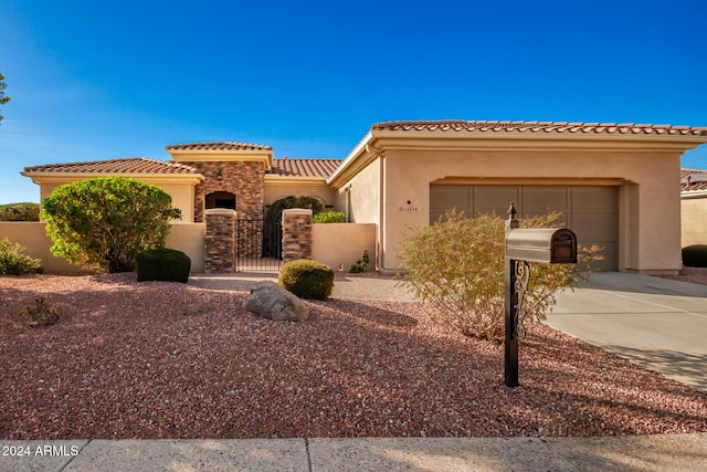 mediterranean / spanish-style home with a garage