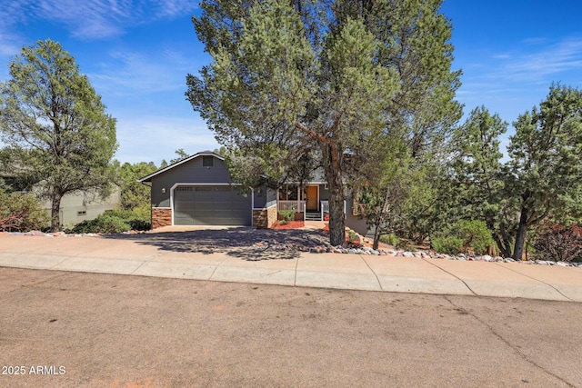 809 W St Moritz Dr, Payson, AZ 85541 - obstructed view of property featuring stone siding, concrete driveway, and an attached garage