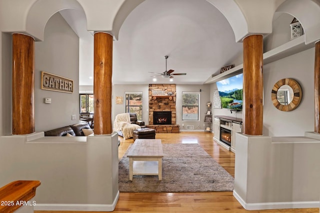 809 W St Moritz Dr, Payson, AZ 85541 - living area with a ceiling fan, a stone fireplace, light wood-style floors, and ornate columns