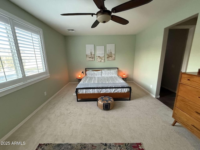 carpeted bedroom with baseboards, visible vents, and ceiling fan