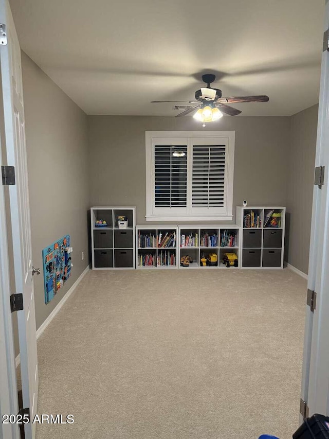 game room with a ceiling fan, carpet, and baseboards