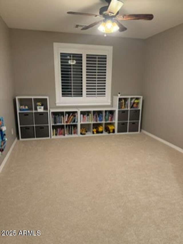 game room featuring baseboards, ceiling fan, and carpet flooring