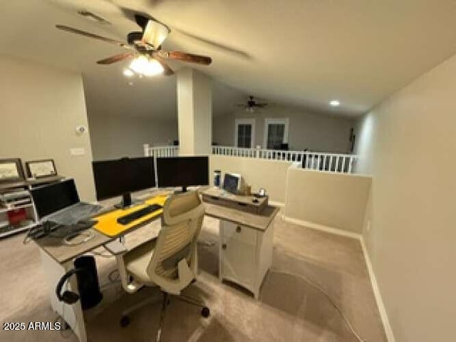 office with baseboards, light colored carpet, ceiling fan, and vaulted ceiling