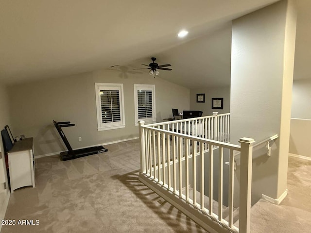 hall featuring baseboards, an upstairs landing, carpet, and vaulted ceiling