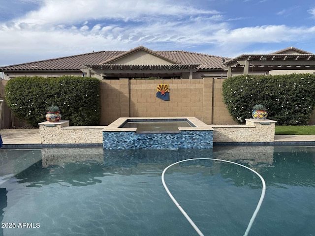 view of swimming pool featuring an in ground hot tub and fence