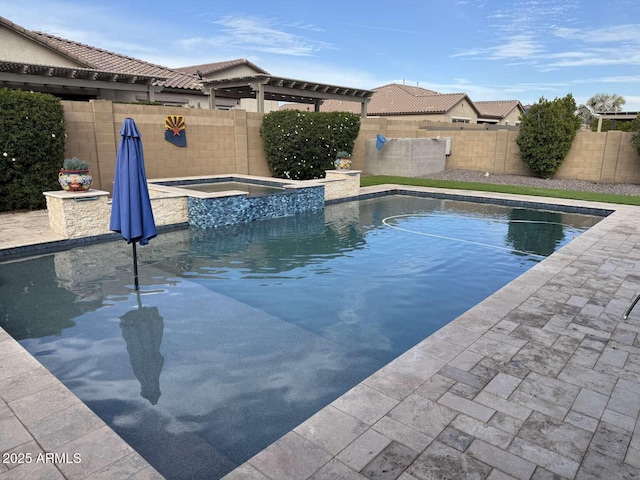 view of swimming pool with a patio, a fenced backyard, and a pool with connected hot tub