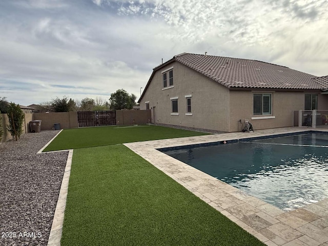 view of pool with a yard, a patio area, a fenced in pool, and a fenced backyard