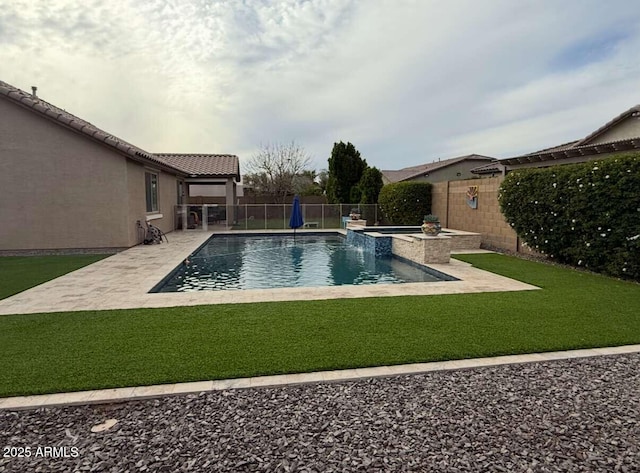 view of swimming pool featuring a patio area, a lawn, a pool with connected hot tub, and a fenced backyard