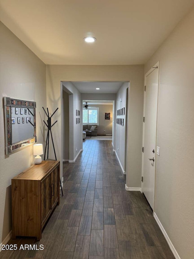 corridor featuring recessed lighting, baseboards, and wood tiled floor