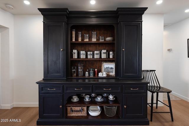 bar featuring light hardwood / wood-style floors