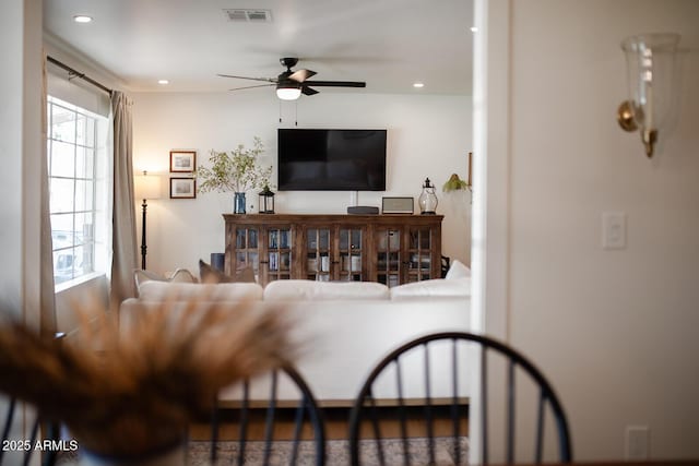 living room with plenty of natural light and ceiling fan