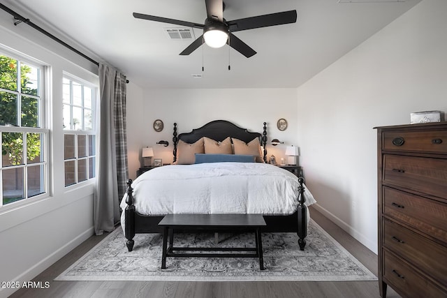 bedroom with dark hardwood / wood-style floors and ceiling fan