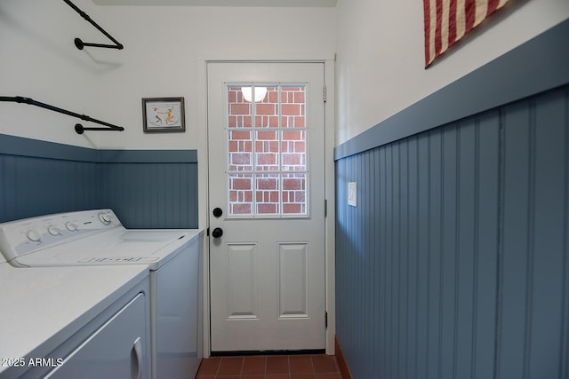 laundry area with independent washer and dryer and dark tile patterned floors