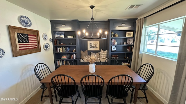 dining area with a notable chandelier and dark wood-type flooring