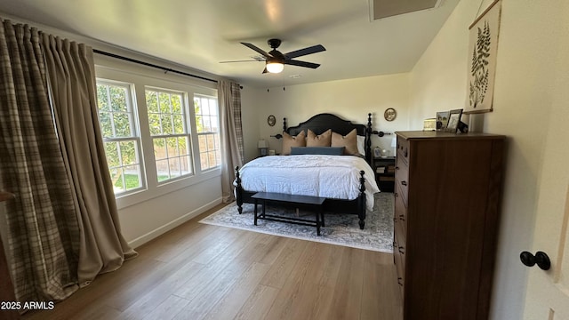 bedroom with ceiling fan and light wood-type flooring