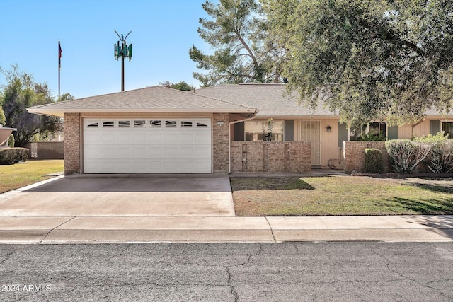 ranch-style house featuring a garage and a front yard