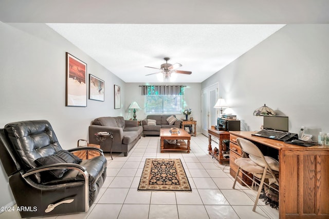 living room featuring light tile patterned floors, a textured ceiling, and ceiling fan