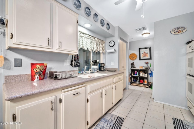 kitchen with light tile patterned floors, ceiling fan, and sink