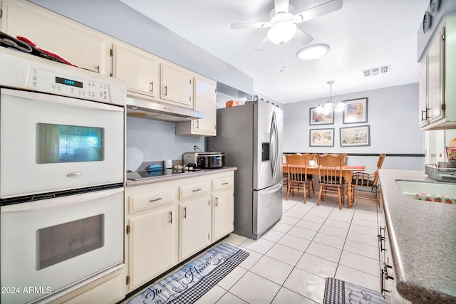 kitchen with white double oven, stainless steel fridge with ice dispenser, pendant lighting, black electric stovetop, and light tile patterned floors