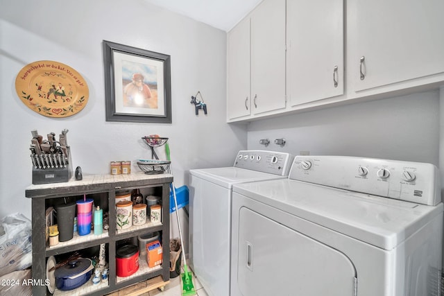 washroom featuring cabinets and independent washer and dryer