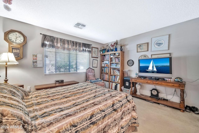 bedroom featuring carpet flooring and a textured ceiling