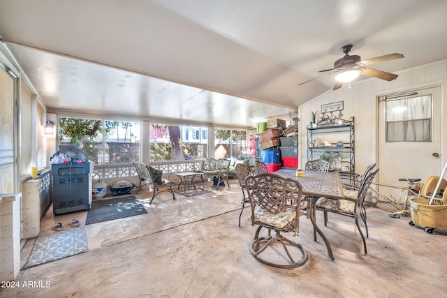 dining space with concrete floors, vaulted ceiling, and ceiling fan