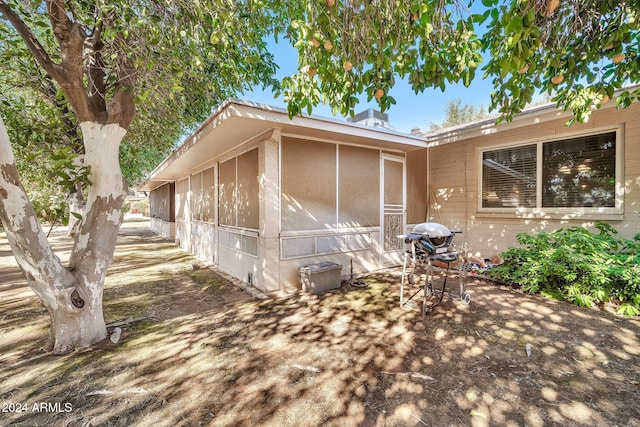 view of property exterior with a sunroom