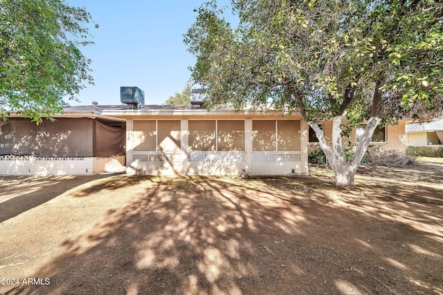 back of property with a sunroom and cooling unit