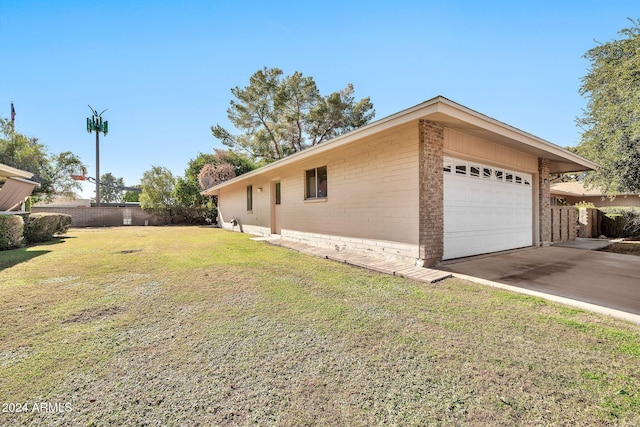 view of side of home with a yard and a garage