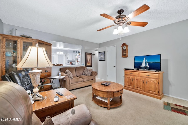 living room featuring light carpet, a textured ceiling, and ceiling fan