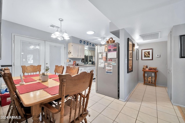 dining space with an inviting chandelier and light tile patterned flooring