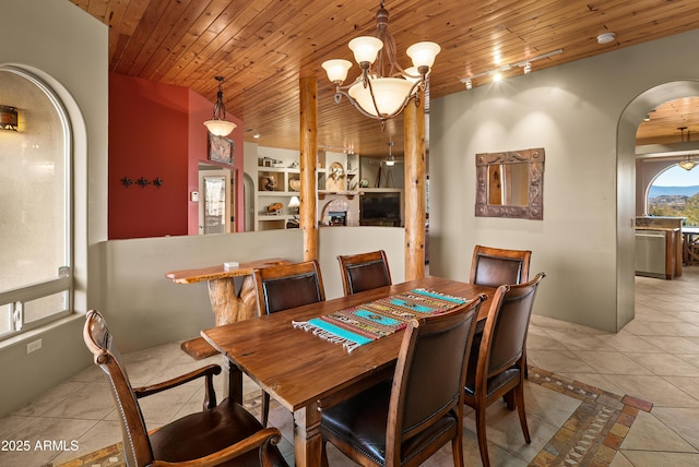 dining room with light tile patterned floors, a notable chandelier, and wooden ceiling