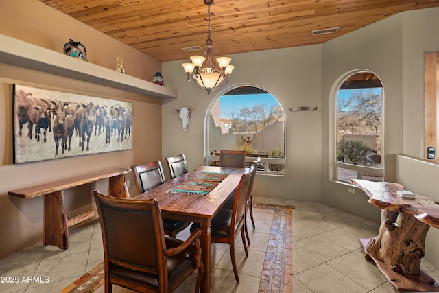 tiled dining room featuring a chandelier and wood ceiling