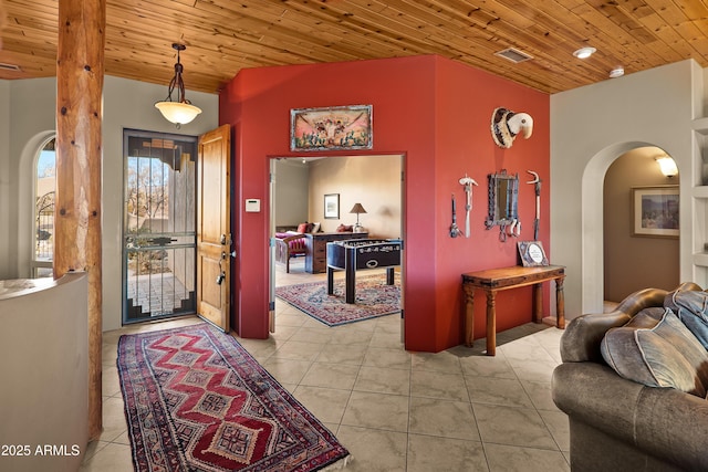 foyer entrance featuring wooden ceiling and light tile patterned floors