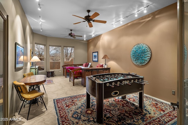 playroom with light tile patterned floors, track lighting, and ceiling fan