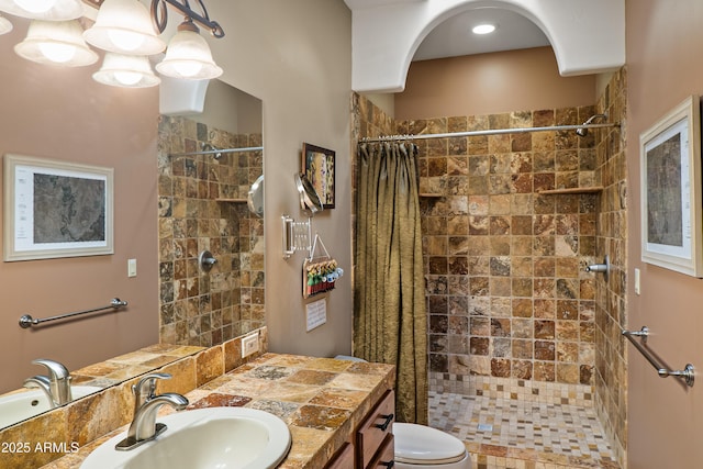 bathroom with toilet, vanity, a chandelier, and a shower with shower curtain