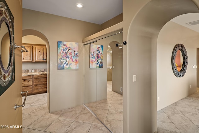 hall with light tile patterned floors