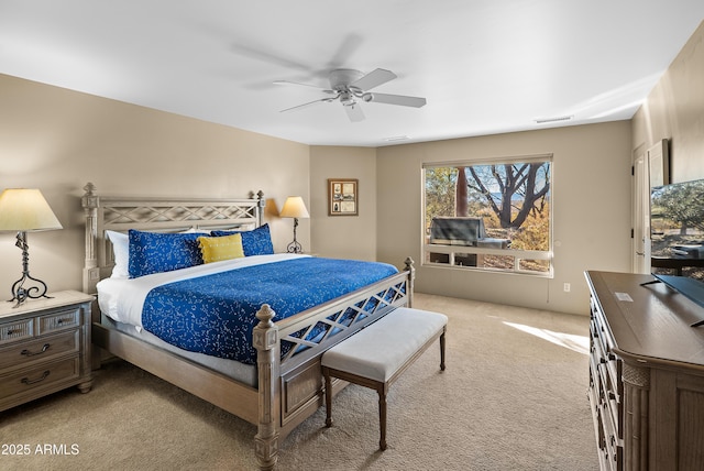 bedroom with ceiling fan and light colored carpet