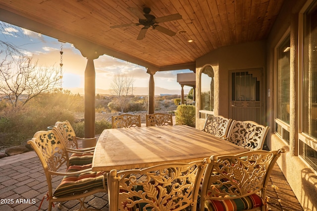 patio terrace at dusk featuring ceiling fan