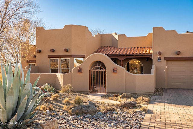 southwest-style home featuring a garage