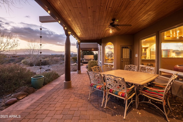 patio terrace at dusk featuring ceiling fan