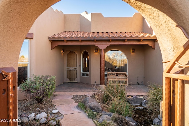 doorway to property with a patio area