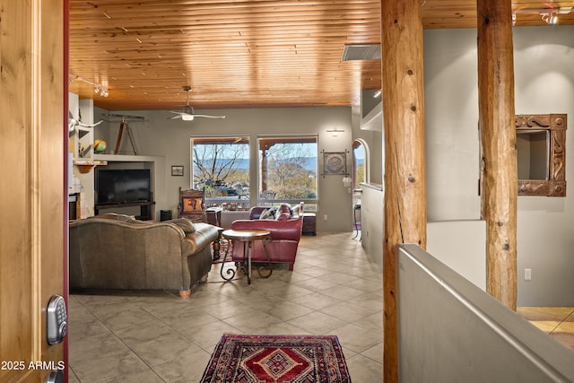 living room with ceiling fan, light tile patterned floors, and wooden ceiling