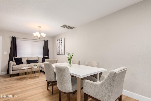 dining space featuring a chandelier and hardwood / wood-style flooring